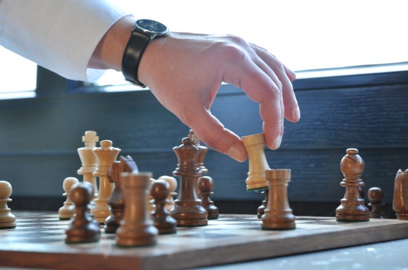 hand moving chess figure